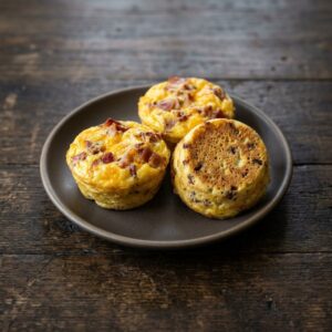 Carnivore egg bites on a wooden board, recipe card view